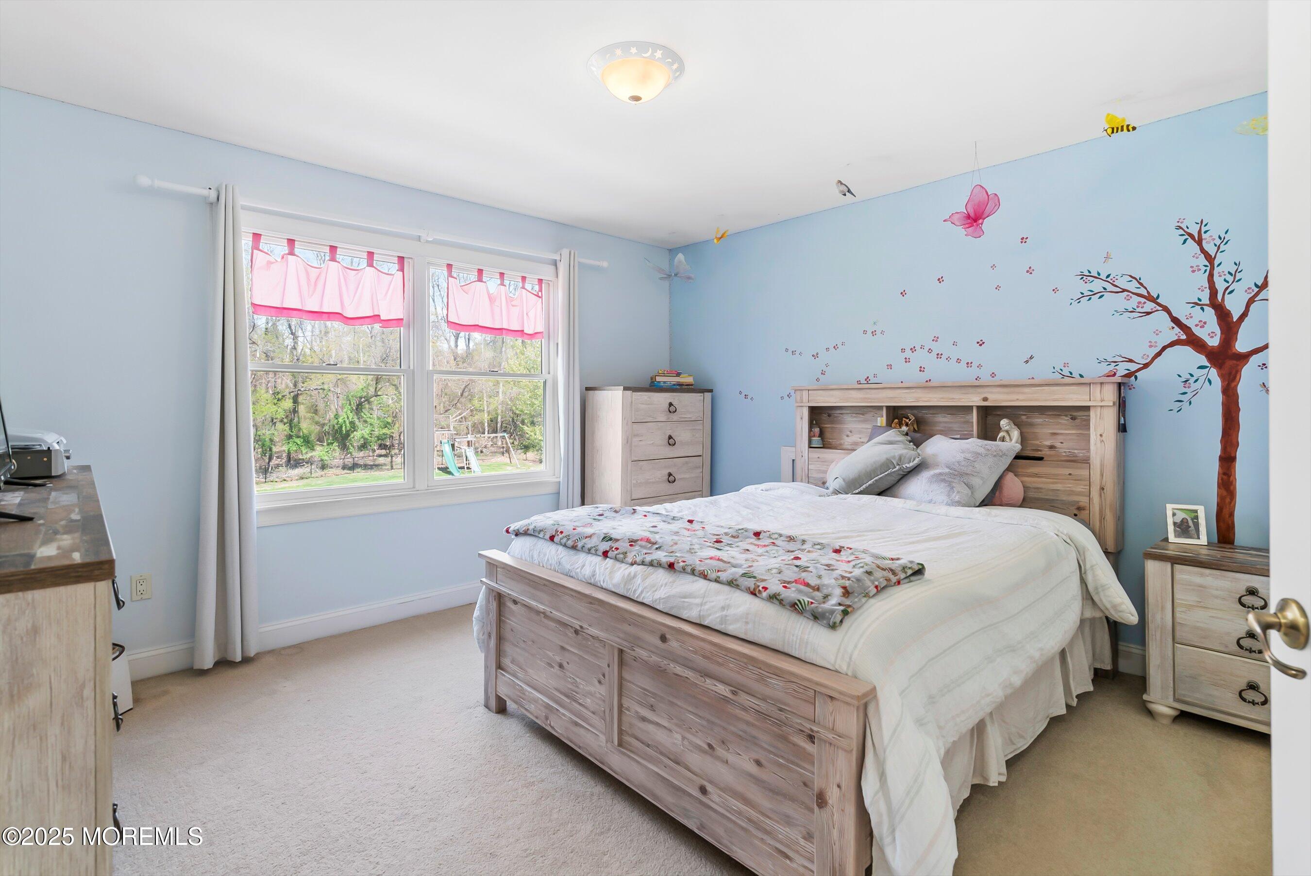 39 Primrose Lane Colts Neck, NJ 07722 - Photo 5 of 52 a bedroom with a bed a dresser and a window