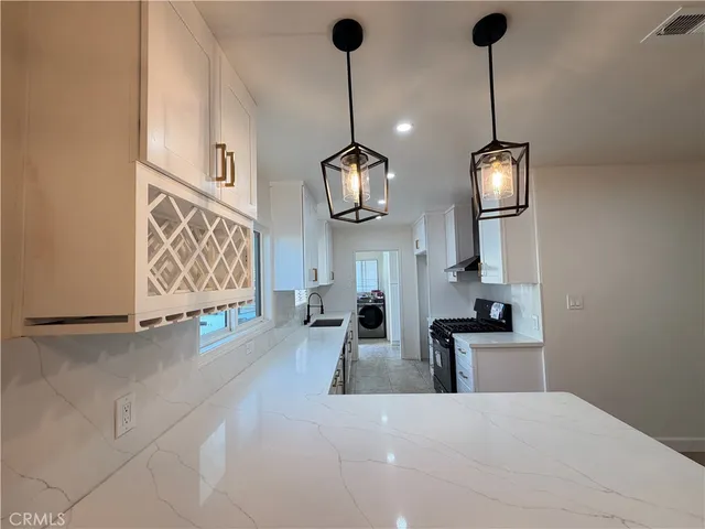 a kitchen with a sink stove and cabinets