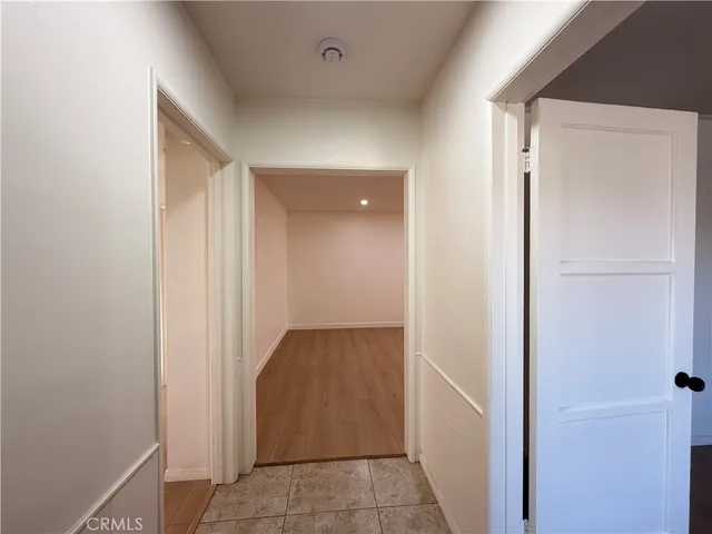 a view of a kitchen with wooden floor and a sink
