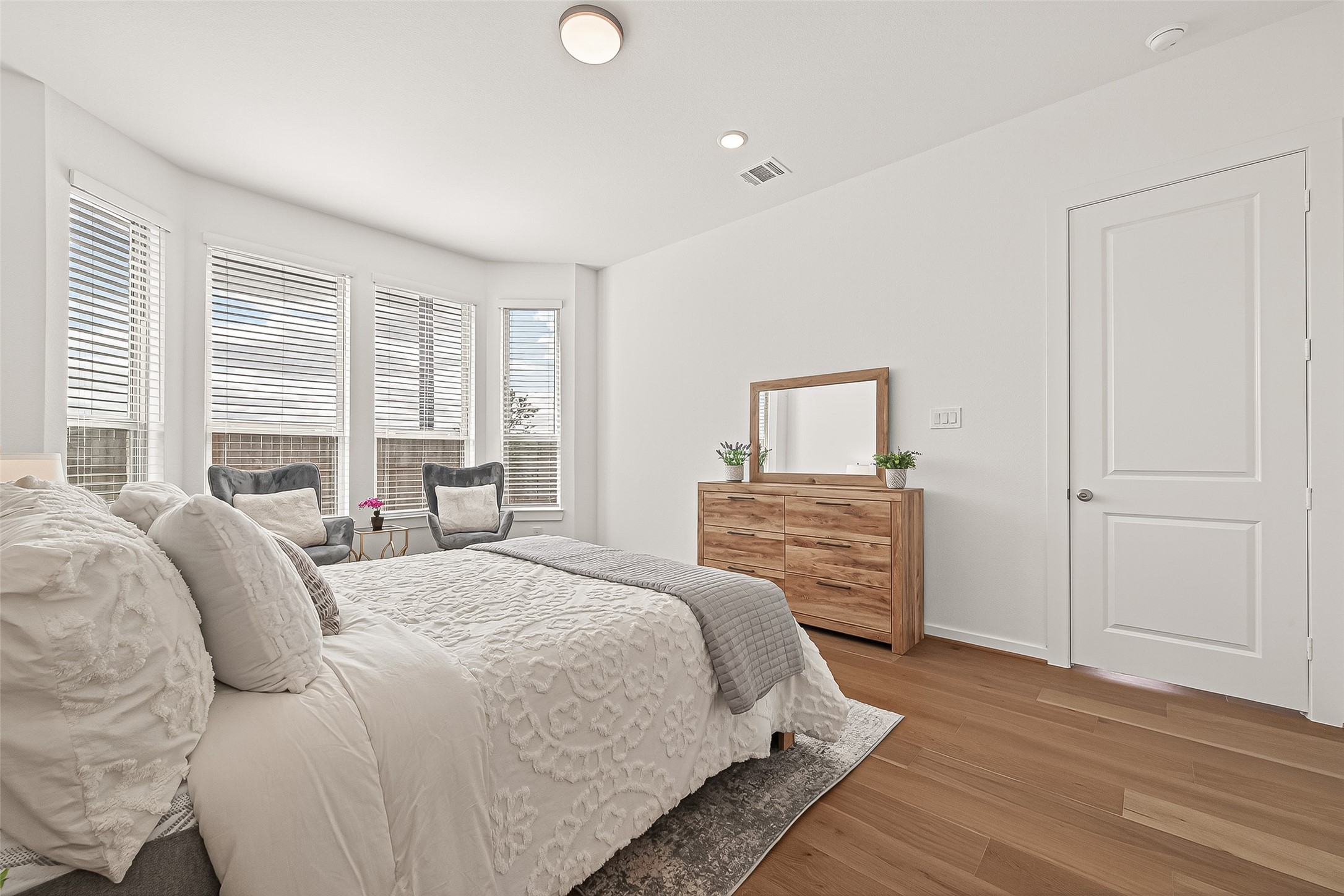 7427 Compass Drive Katy, TX 77493 - Photo 21 of 49 a bedroom with a bed and wooden floor