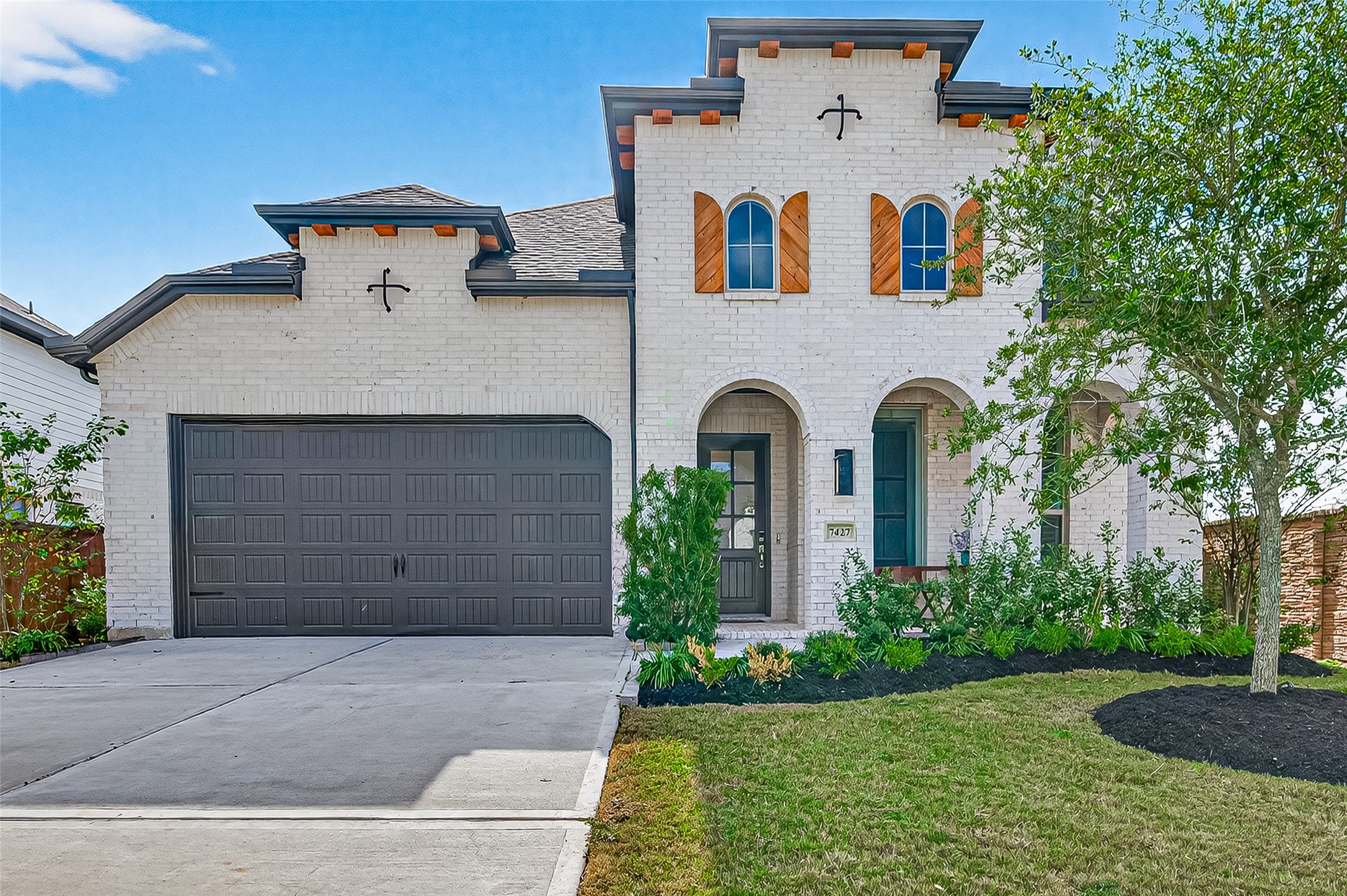 7427 Compass Drive Katy, TX 77493 - Photo 5 of 49 a view of a white house with large windows and garage