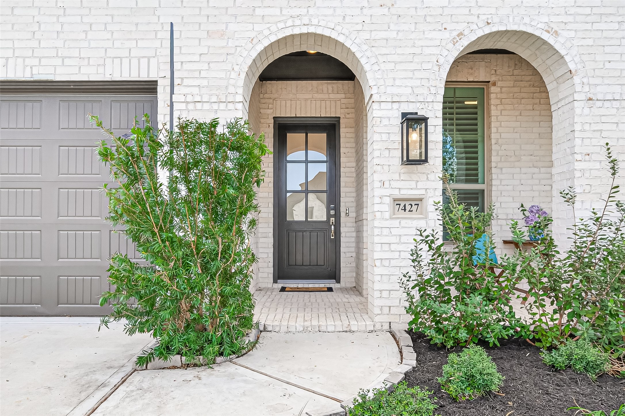 7427 Compass Drive Katy, TX 77493 - Photo 6 of 49 a front view of a house with a garden
