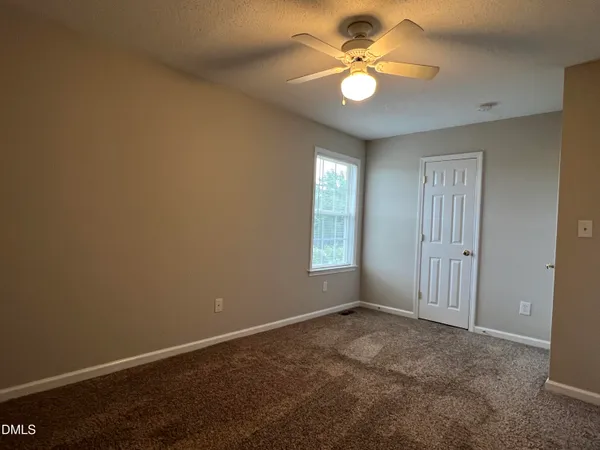a view of a livingroom with wooden floor and a hallway