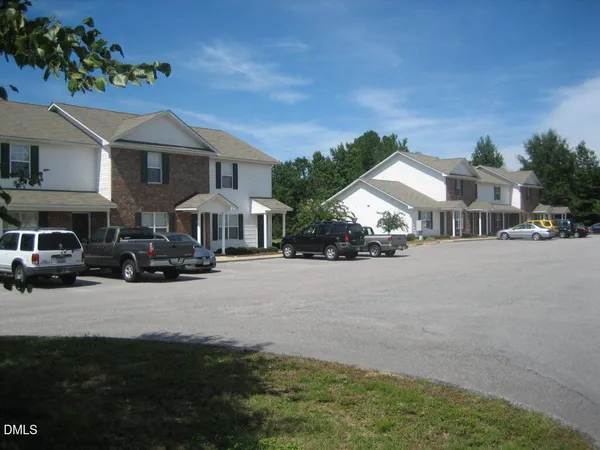 a couple of cars parked in front of a house