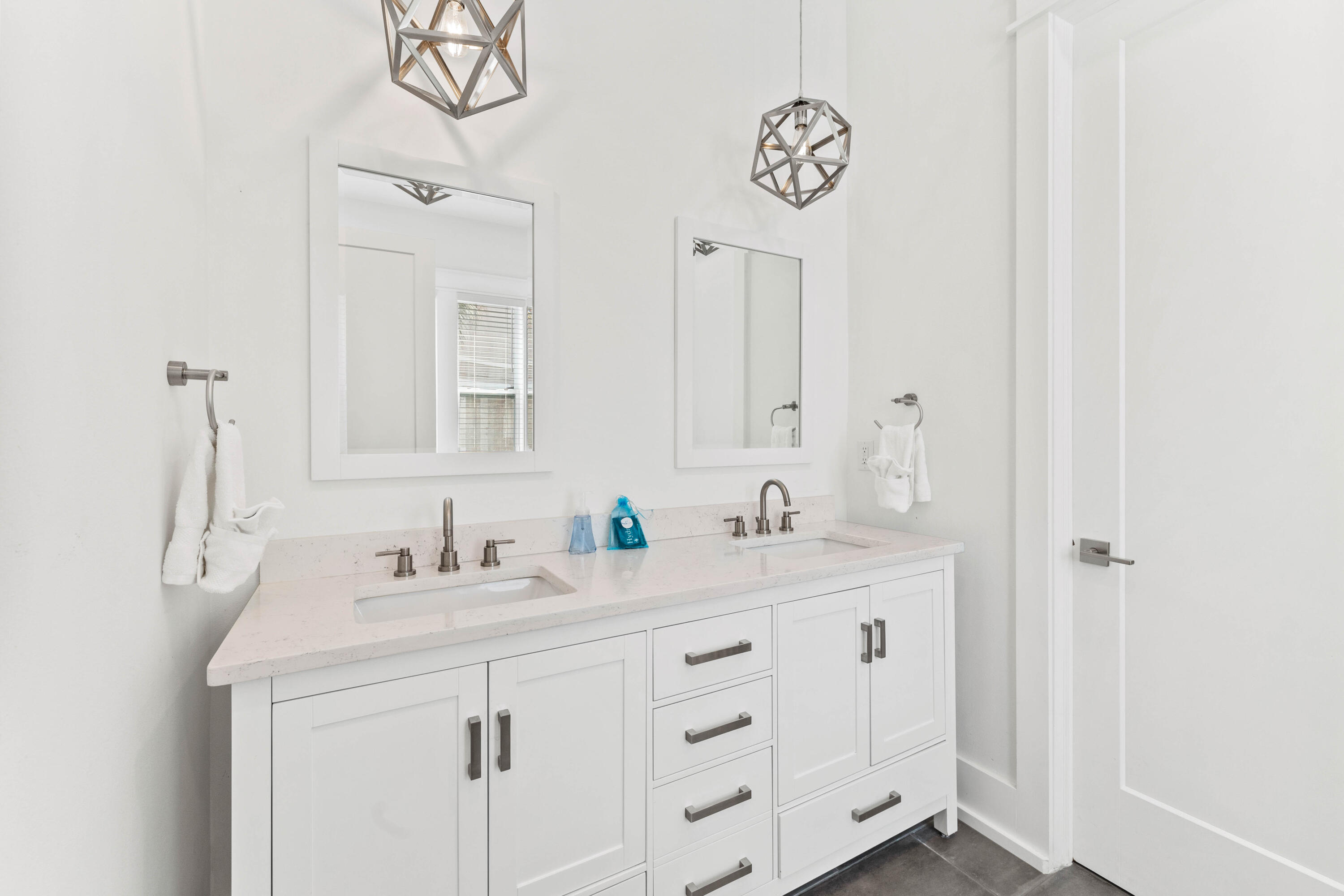 4635 Sunset Pointe Destin, FL 32541 - Photo 13 of 48 a bathroom with a sink vanity and a mirror