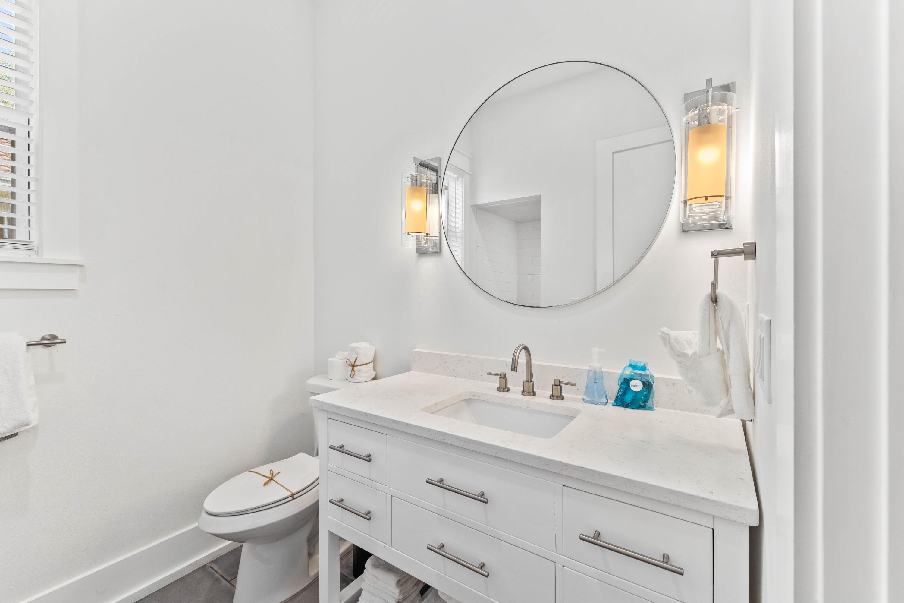 4635 Sunset Pointe Destin, FL 32541 - Photo 17 of 48 a bathroom with a sink mirror vanity and toilet