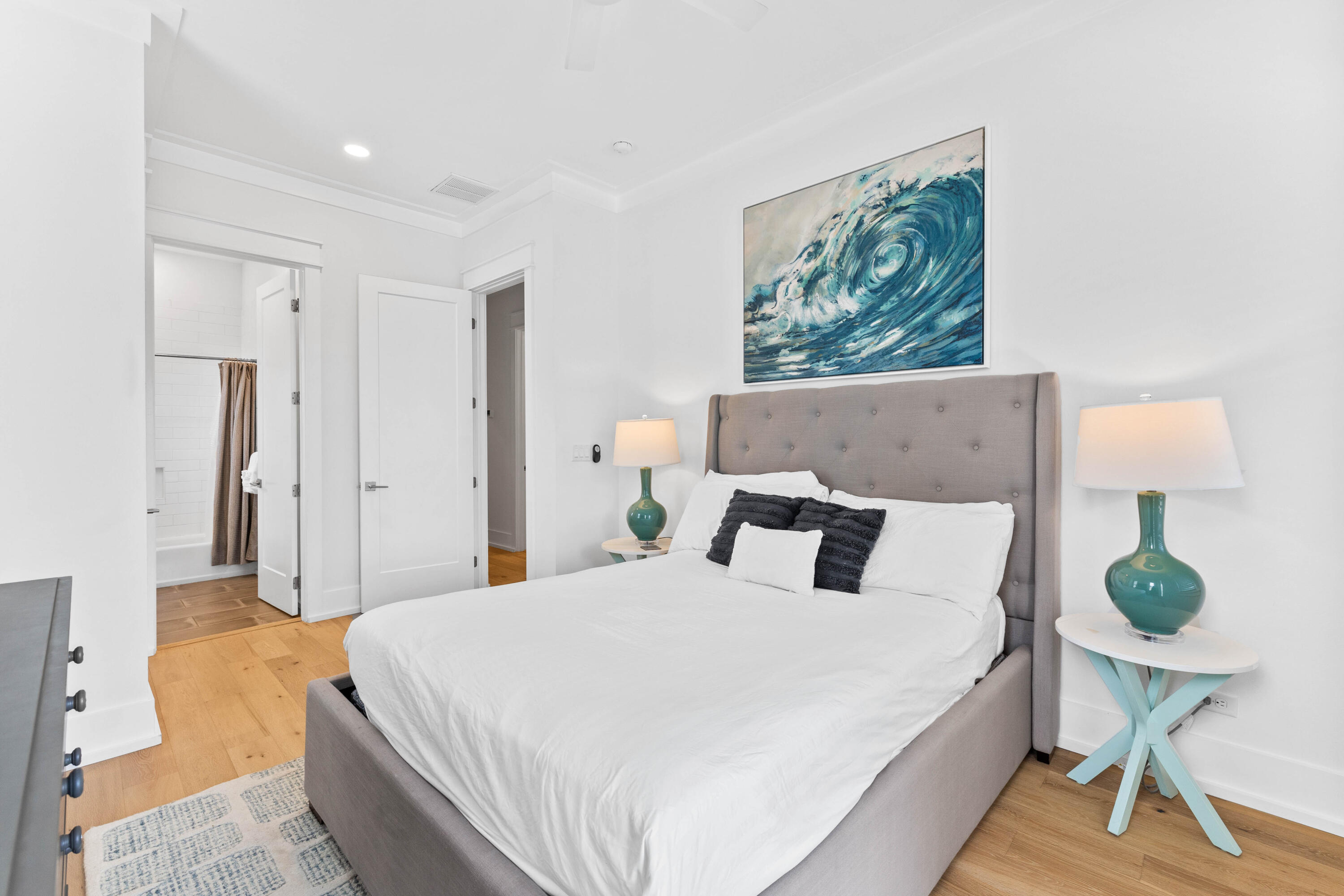 4635 Sunset Pointe Destin, FL 32541 - Photo 26 of 48 a bedroom with a bed mirror and wall painting