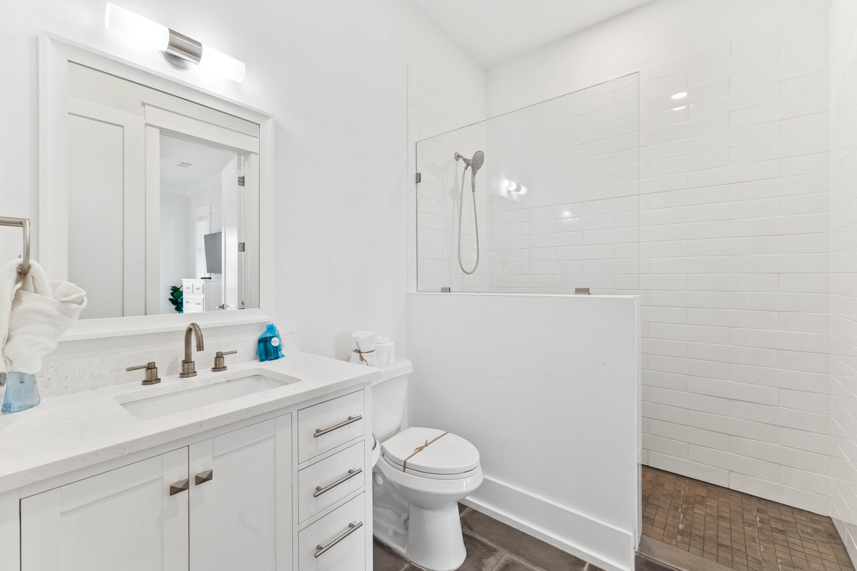 4635 Sunset Pointe Destin, FL 32541 - Photo 31 of 48 a bathroom with a sink a toilet and a mirror