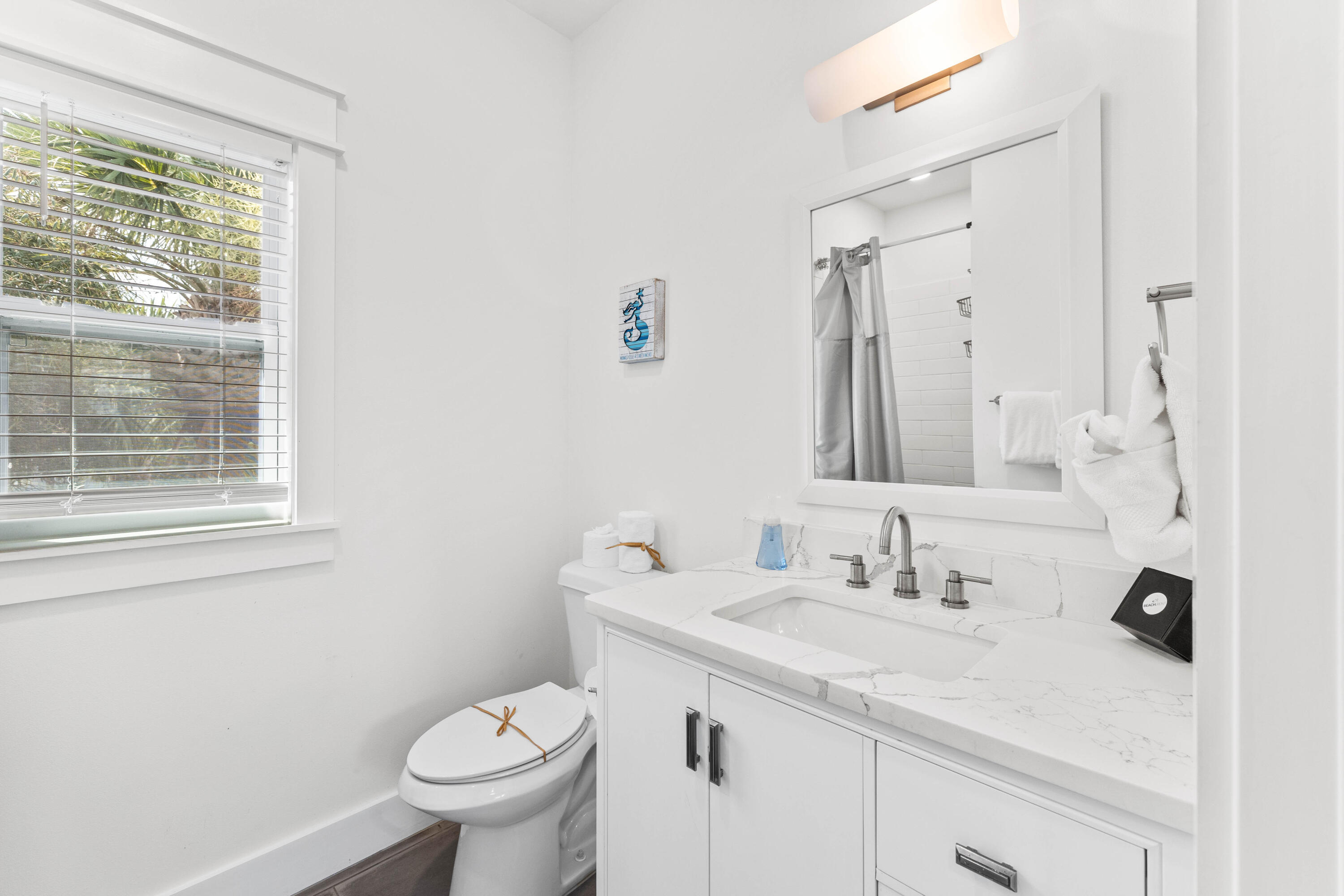 4635 Sunset Pointe Destin, FL 32541 - Photo 34 of 48 a bathroom with a sink toilet and a mirror