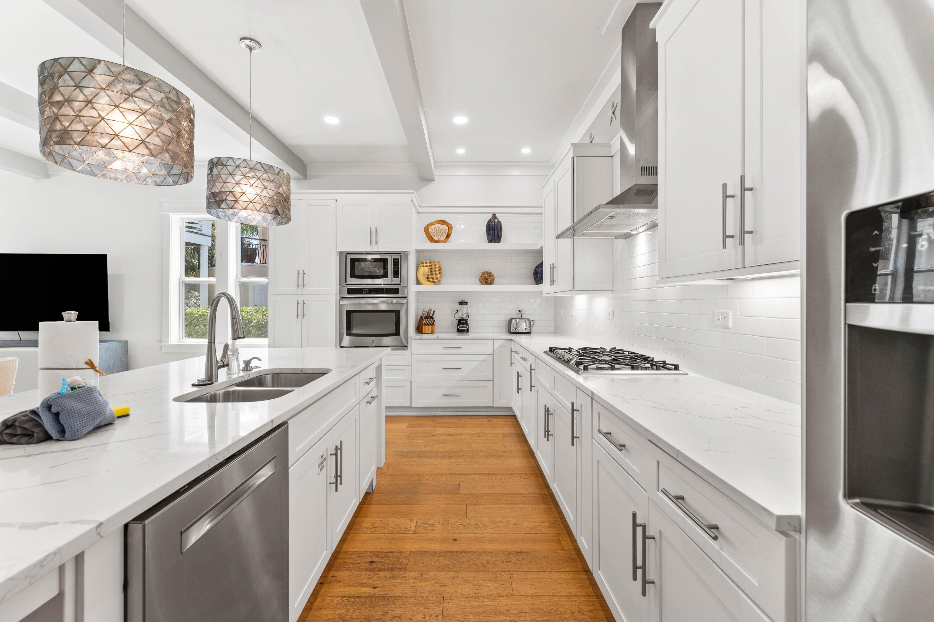 4635 Sunset Pointe Destin, FL 32541 - Photo 7 of 48 a large kitchen with stainless steel appliances lots of counter space and wooden floor