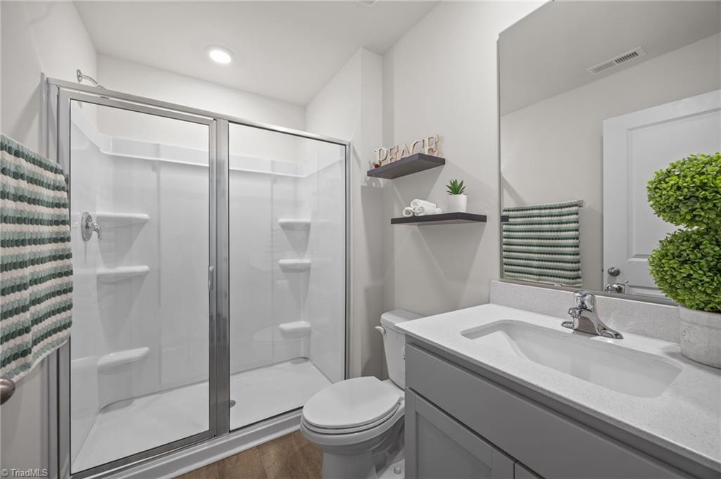 4574 Heatherly Road Winston-Salem, NC 27105 - Photo 15 of 41 Full bathroom across room on main, with walk-in shower