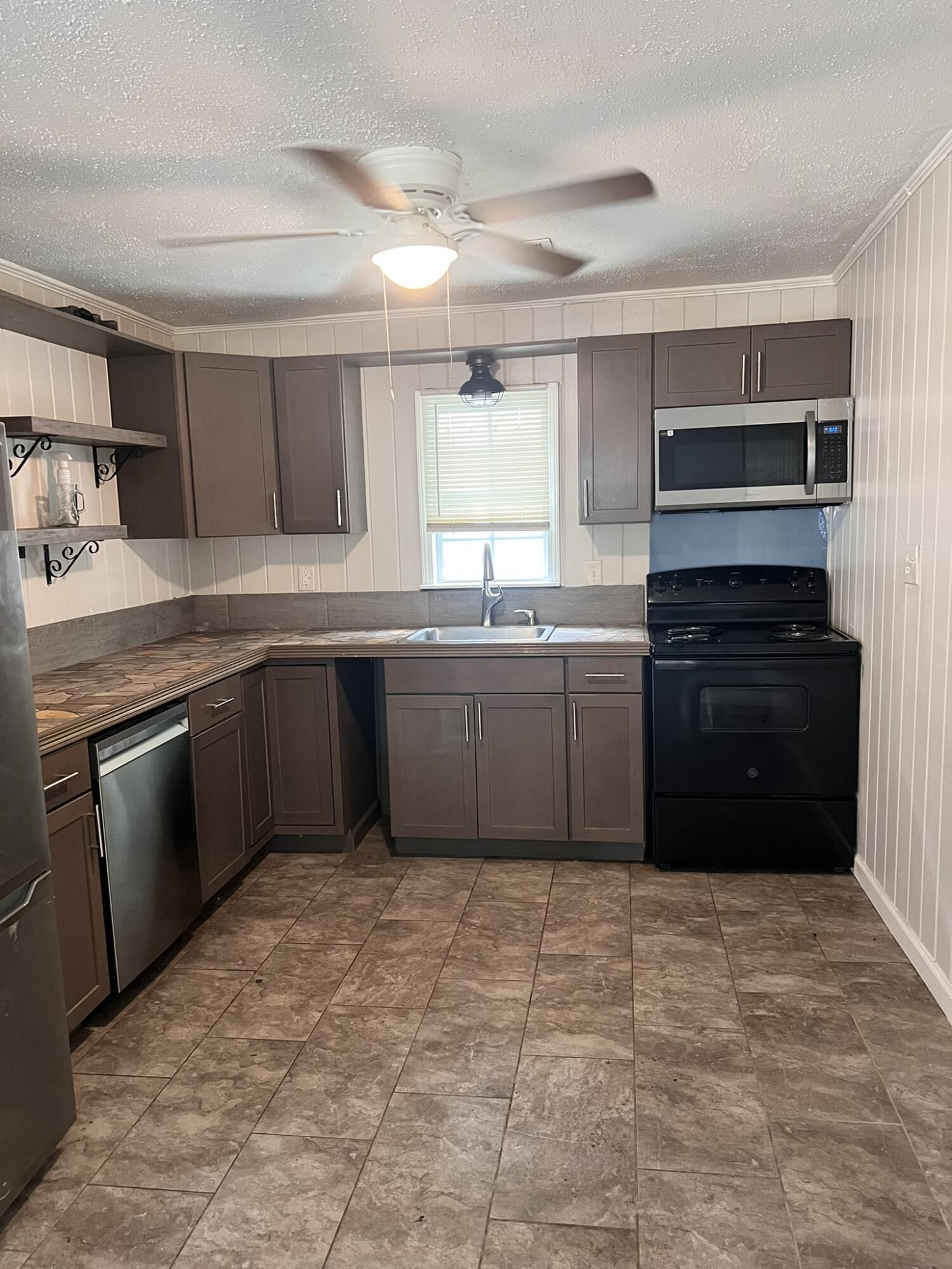 2361 Susan Drive Crestview, FL 32536 - Photo 2 of 12 a kitchen with stainless steel appliances granite countertop a sink counter top space and cabinets