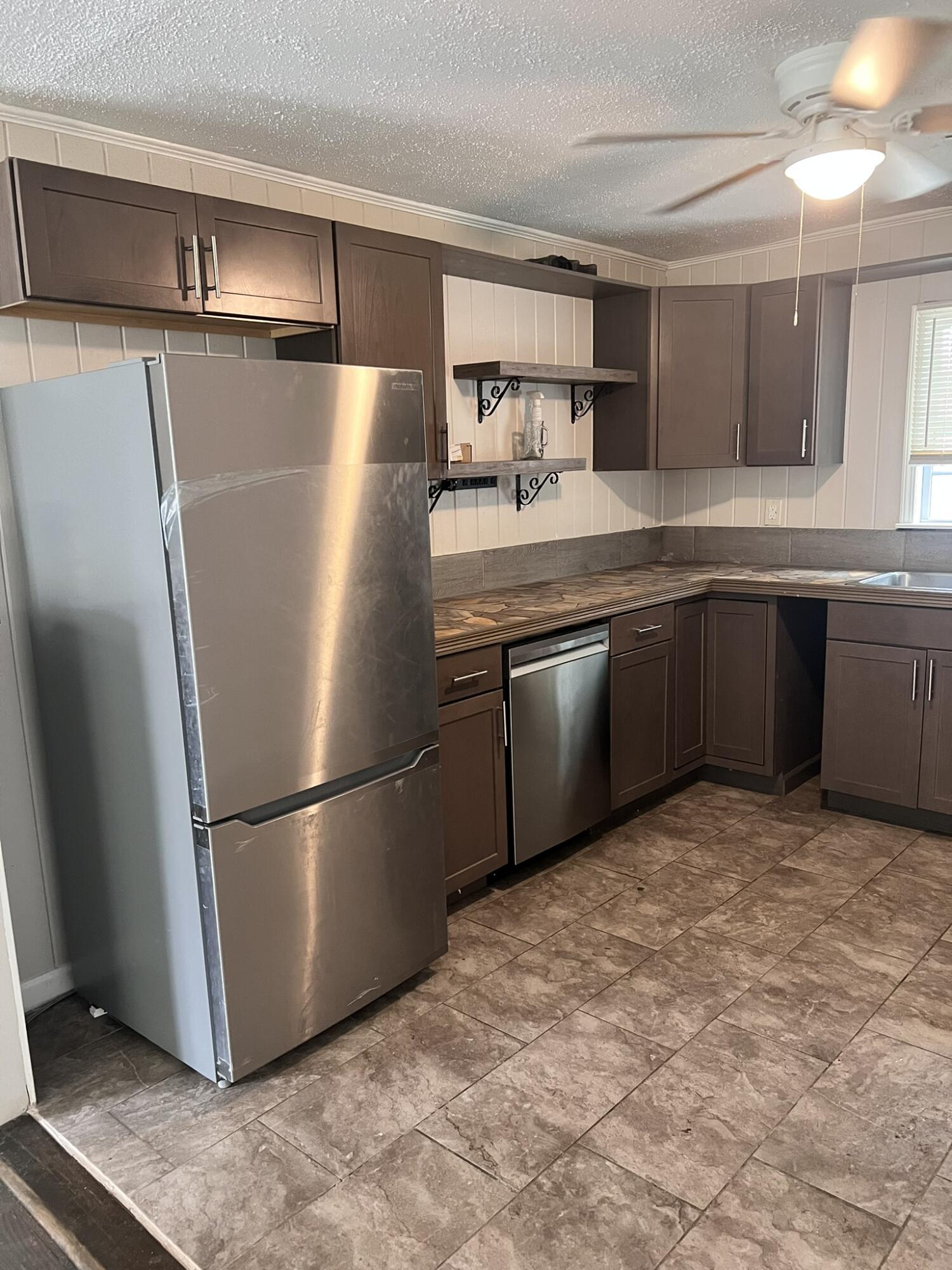 2361 Susan Drive Crestview, FL 32536 - Photo 3 of 12 a kitchen with stainless steel appliances granite countertop a refrigerator sink and cabinets