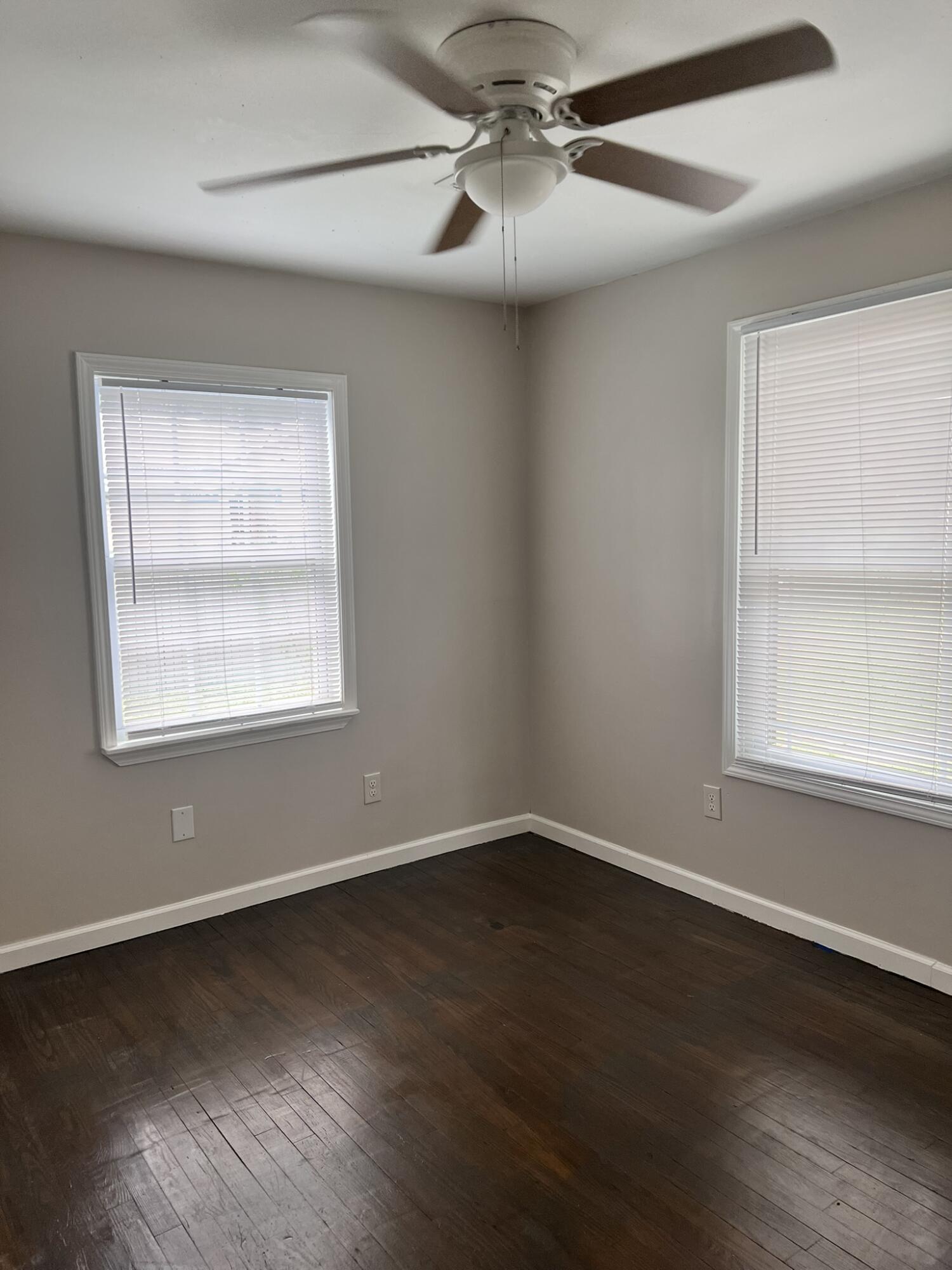 2361 Susan Drive Crestview, FL 32536 - Photo 8 of 12 a view of an empty room with wooden floor and a window