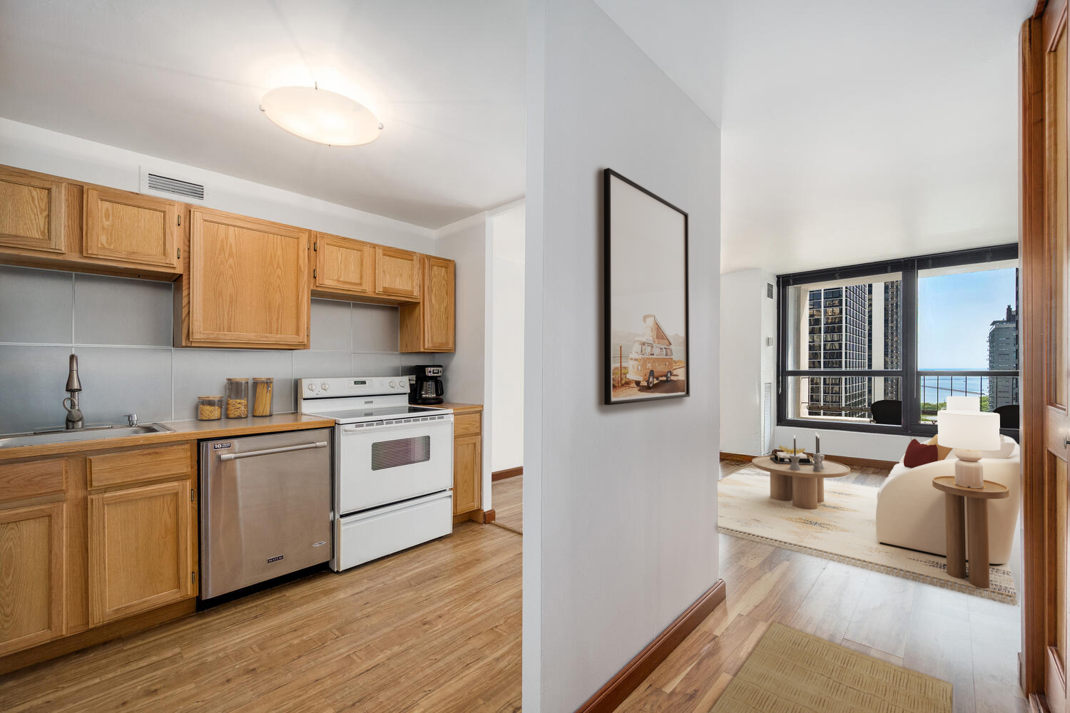 1030 North State Street, Unit 9G Chicago, IL 60610 - Photo 12 of 20 a kitchen with stainless steel appliances a stove a sink a refrigerator white cabinets and wooden floor