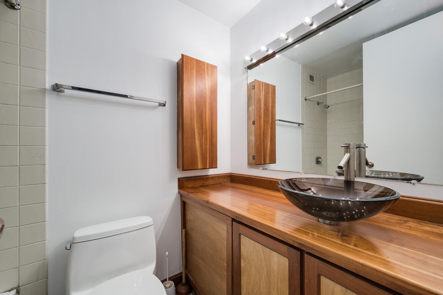 1030 North State Street, Unit 9G Chicago, IL 60610 - Photo 16 of 20 a bathroom with a granite countertop sink and a mirror