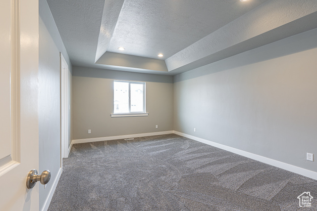2242 South 1120 West, Unit 69 Logan, UT 84321 - Photo 20 of 26 Carpeted spare room featuring a raised ceiling, recessed lighting, and a textured ceiling