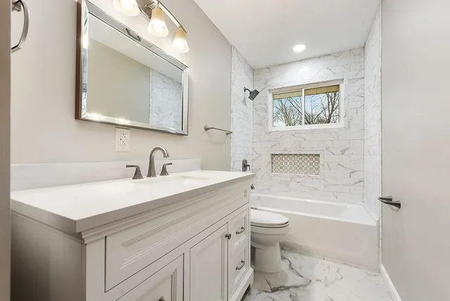 a bathroom with a sink a toilet and a bathtub