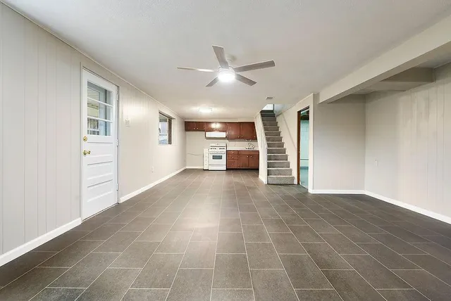 a view of empty room with wooden floor and window