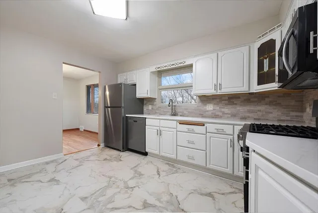 a kitchen with stainless steel appliances granite countertop a refrigerator sink and cabinets