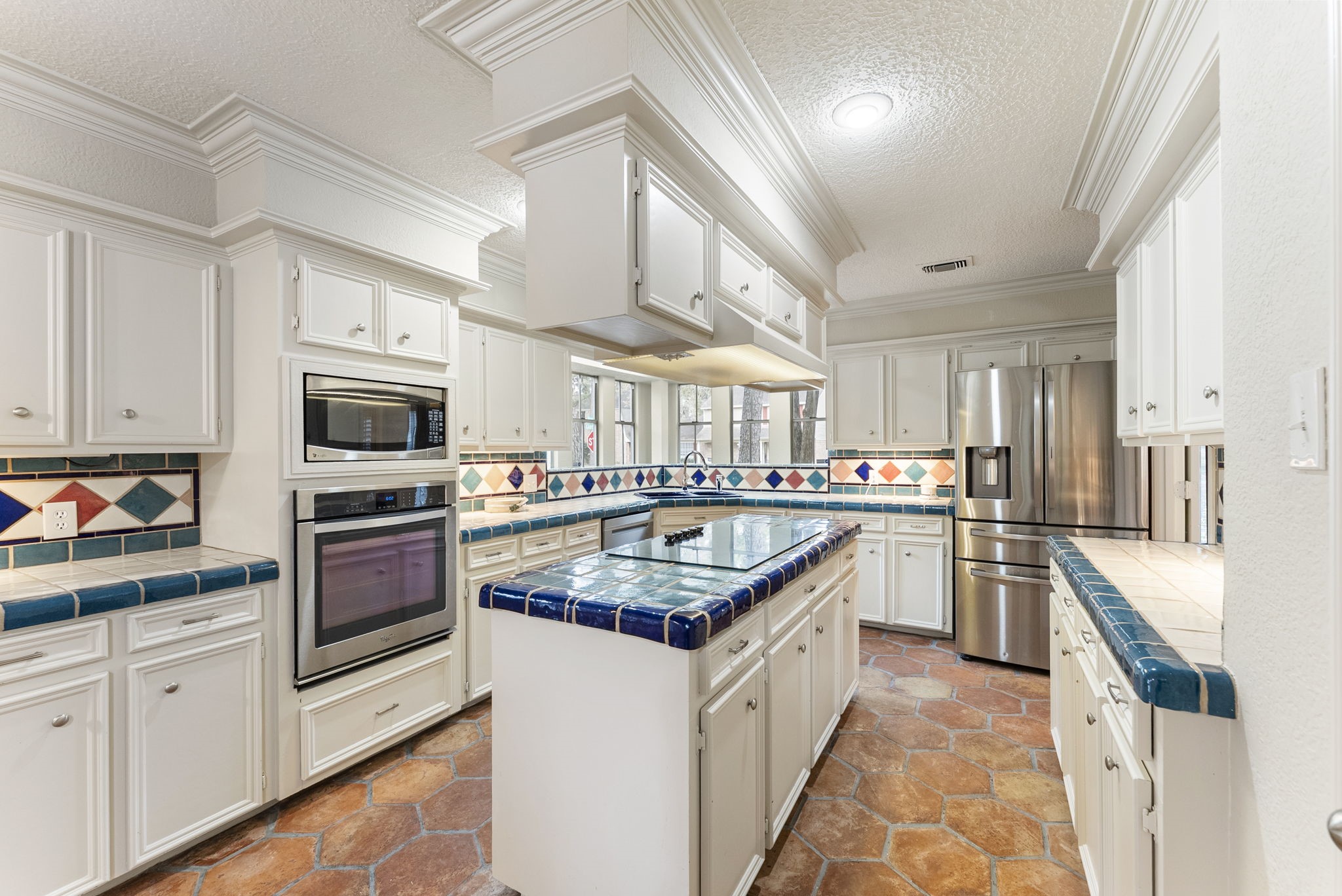 5718 Glenmere Lane Spring, TX 77379 - Photo 12 of 40 a kitchen with stainless steel appliances granite countertop a sink and dishwasher a stove top oven with wooden floor