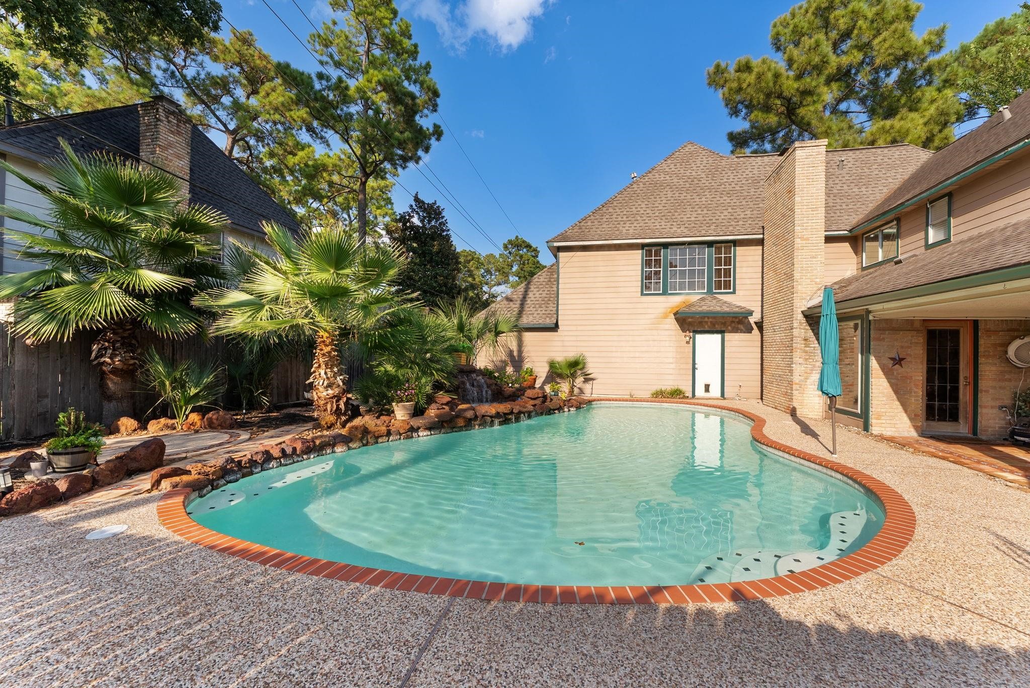 5718 Glenmere Lane Spring, TX 77379 - Photo 36 of 40 The backyard features a sparkling in-ground pool, perfect for relaxation
and entertaining.