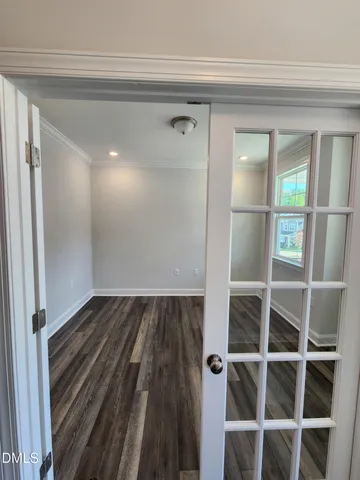 a view of a hallway with wooden floor and staircase