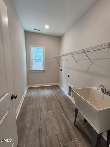 a view of a room with wooden floor and chair