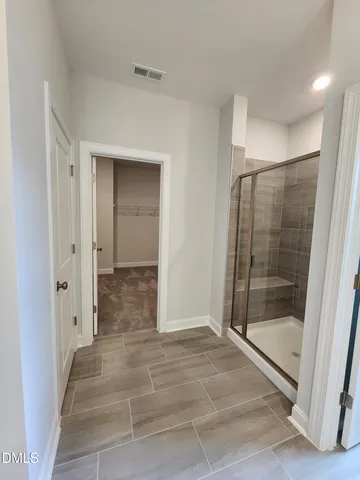 a bathroom with a glass shower door