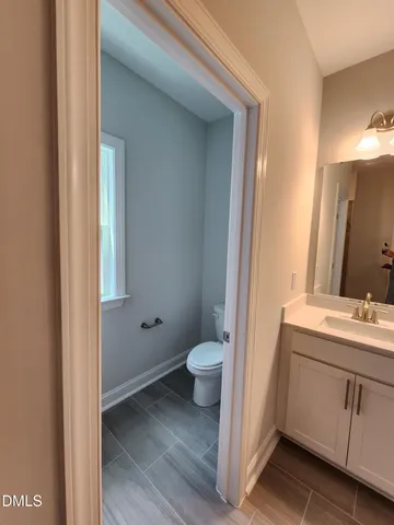 a bathroom with double vanity sink and a mirror