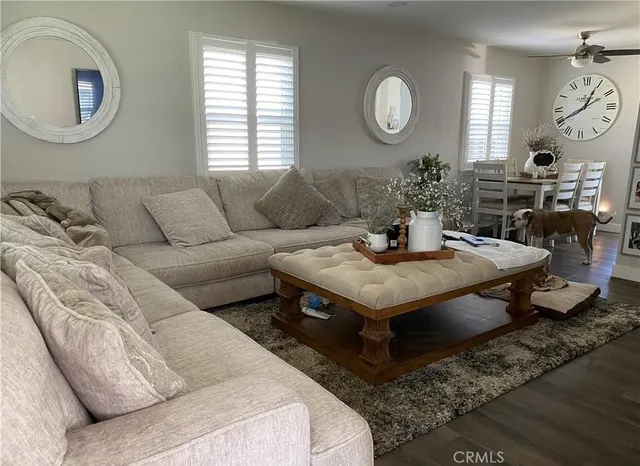 a living room with furniture a mirror and a window