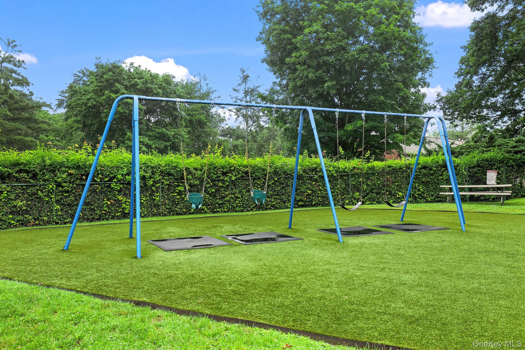186 Pinewood Road, Unit 56 Hartsdale, NY 10530 - Photo 26 of 29 The playground has swing sets, and benches for sitting