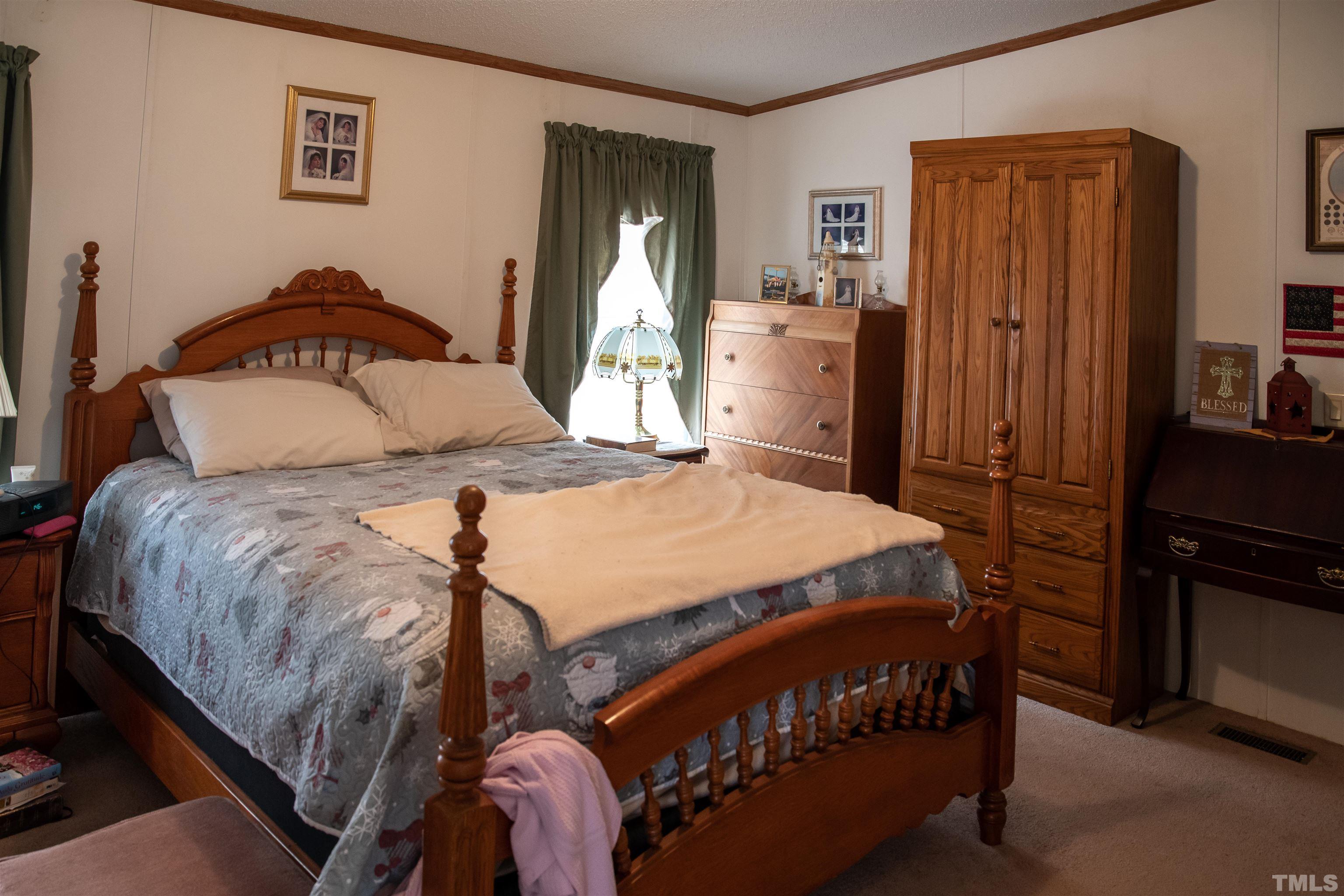 914 Stoney Mountain Road Rougemont, NC 27572 - Photo 7 of 19 a bedroom with a bed and a chandelier