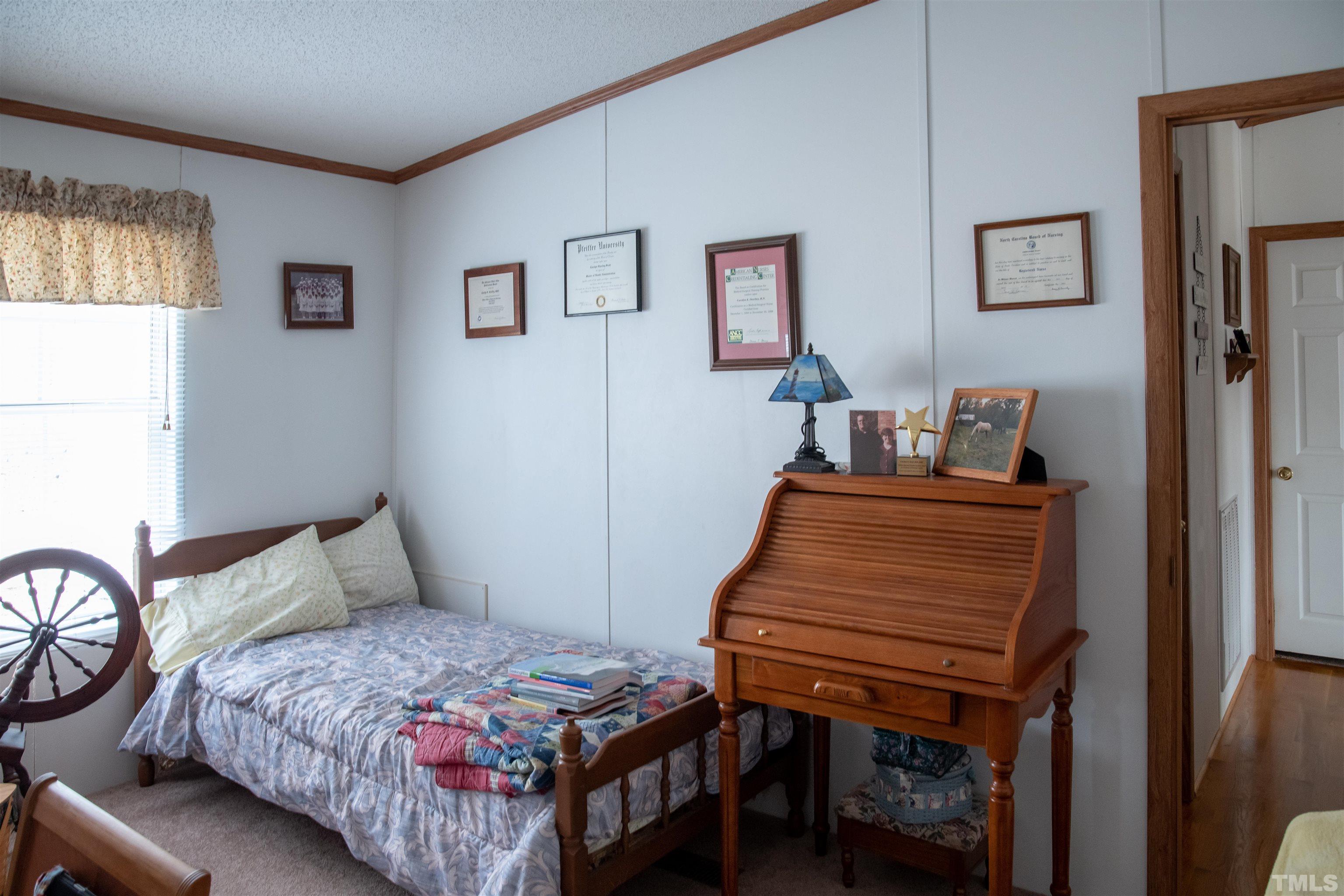 914 Stoney Mountain Road Rougemont, NC 27572 - Photo 10 of 19 a bedroom with a bed and wooden floor