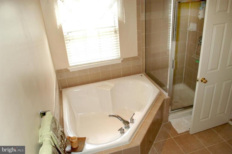 9823 Davison Road Middle River, MD 21220 - Photo 12 of 22 a bathroom with a tub and shower