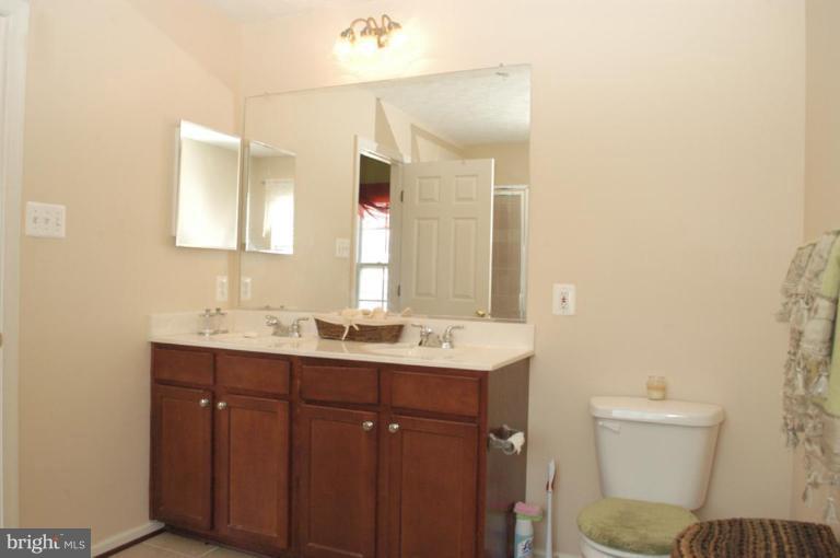 9823 Davison Road Middle River, MD 21220 - Photo 13 of 22 a bathroom with a toilet sink and mirror