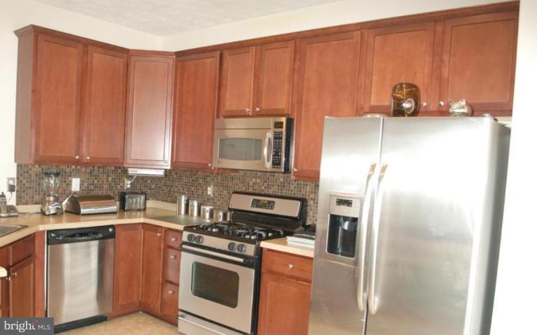 9823 Davison Road Middle River, MD 21220 - Photo 14 of 22 a kitchen with stainless steel appliances granite countertop a refrigerator stove and sink