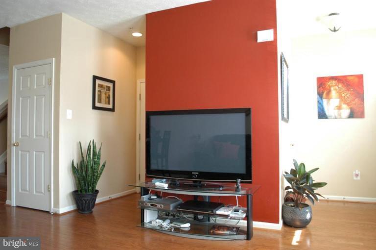 9823 Davison Road Middle River, MD 21220 - Photo 16 of 22 a room with wooden floor and potted plant