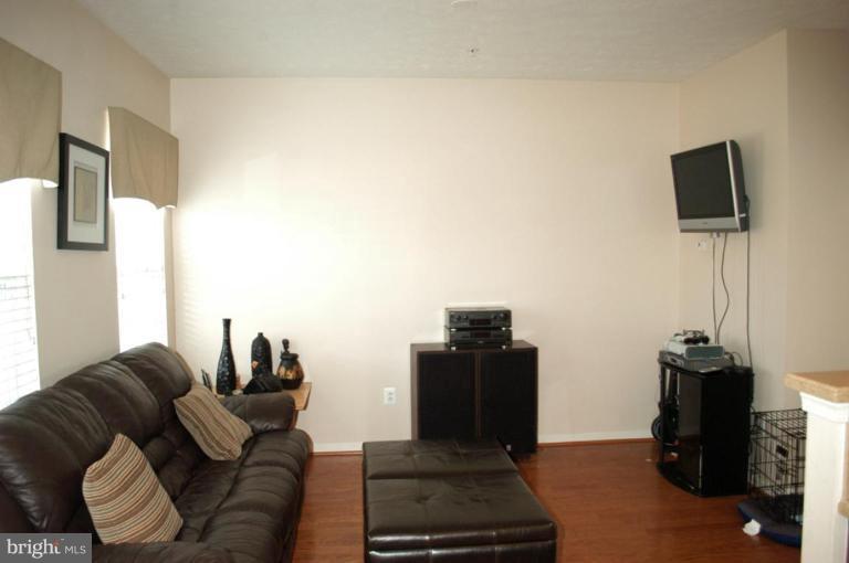 9823 Davison Road Middle River, MD 21220 - Photo 3 of 22 a living room with furniture a flat screen tv and a refrigerator