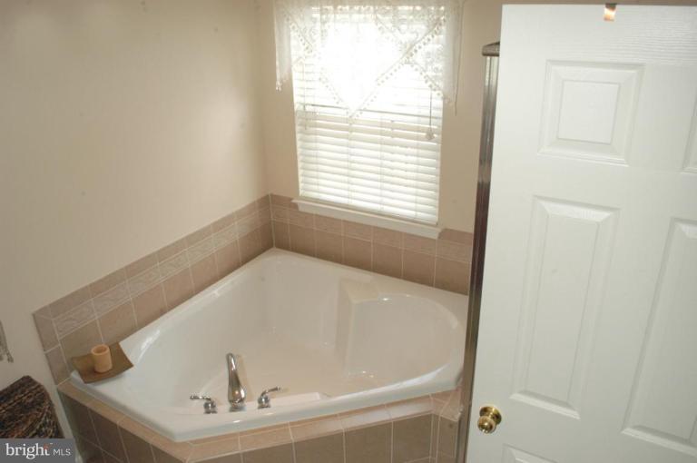 9823 Davison Road Middle River, MD 21220 - Photo 21 of 22 a white bath tub sitting in a bathroom