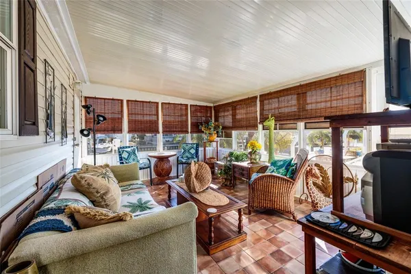 a view of a house with backyard sitting area and porch