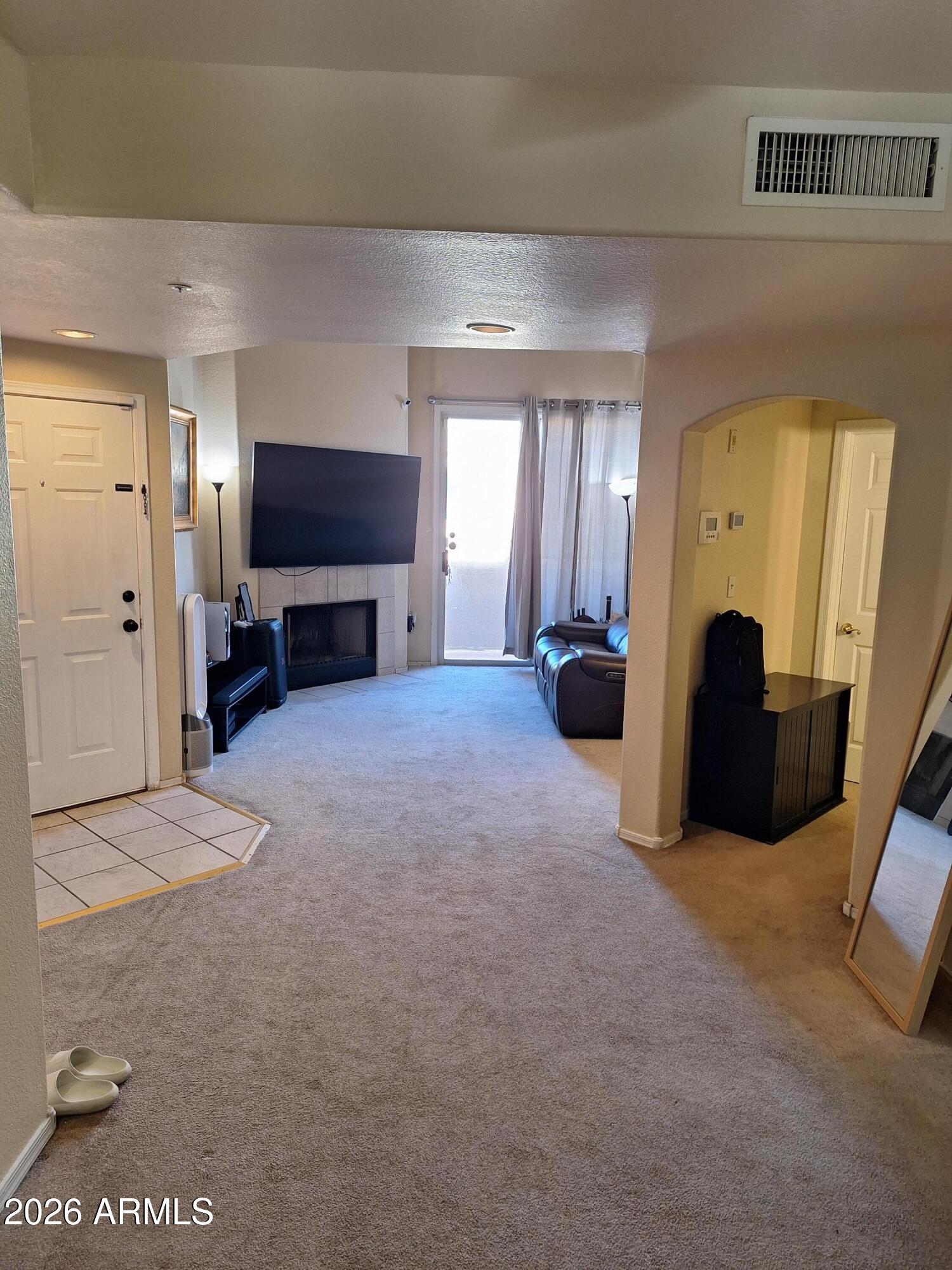 10410 North Cave Creek Road, Unit 2063 Phoenix, AZ 85020 - Photo 22 of 49 a living room with furniture and a flat screen tv