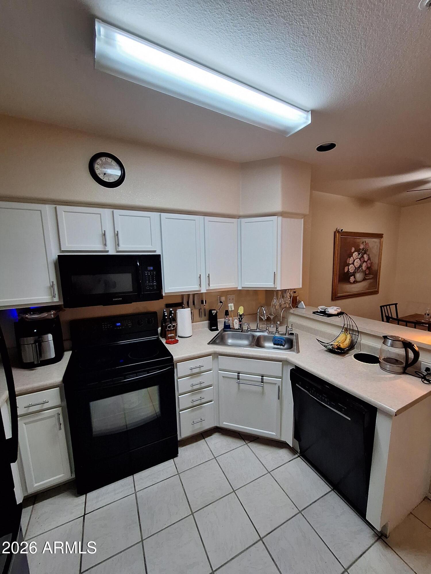 10410 North Cave Creek Road, Unit 2063 Phoenix, AZ 85020 - Photo 29 of 49 a kitchen with a stove and a sink