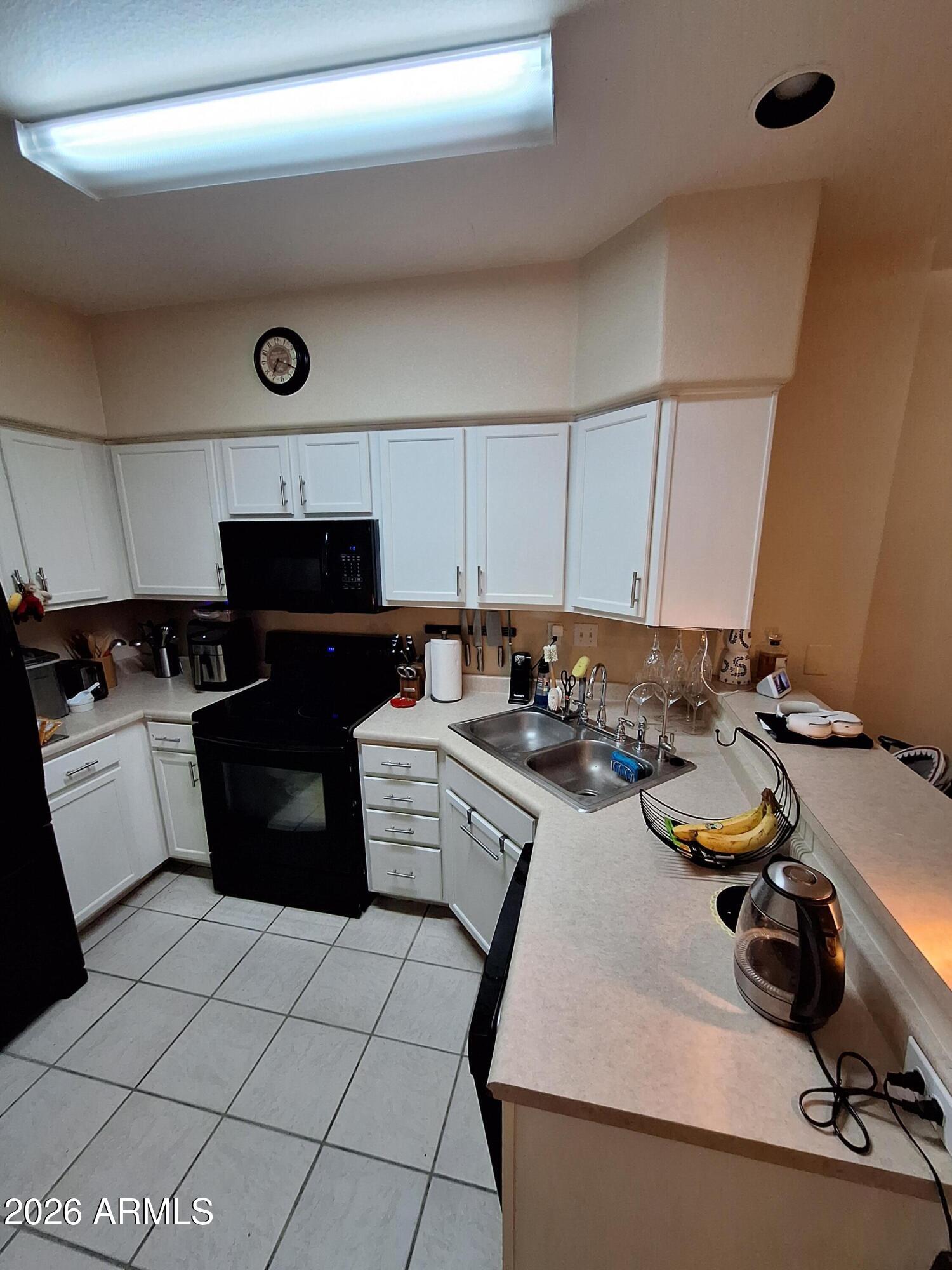10410 North Cave Creek Road, Unit 2063 Phoenix, AZ 85020 - Photo 30 of 49 a kitchen with a sink appliances and cabinets