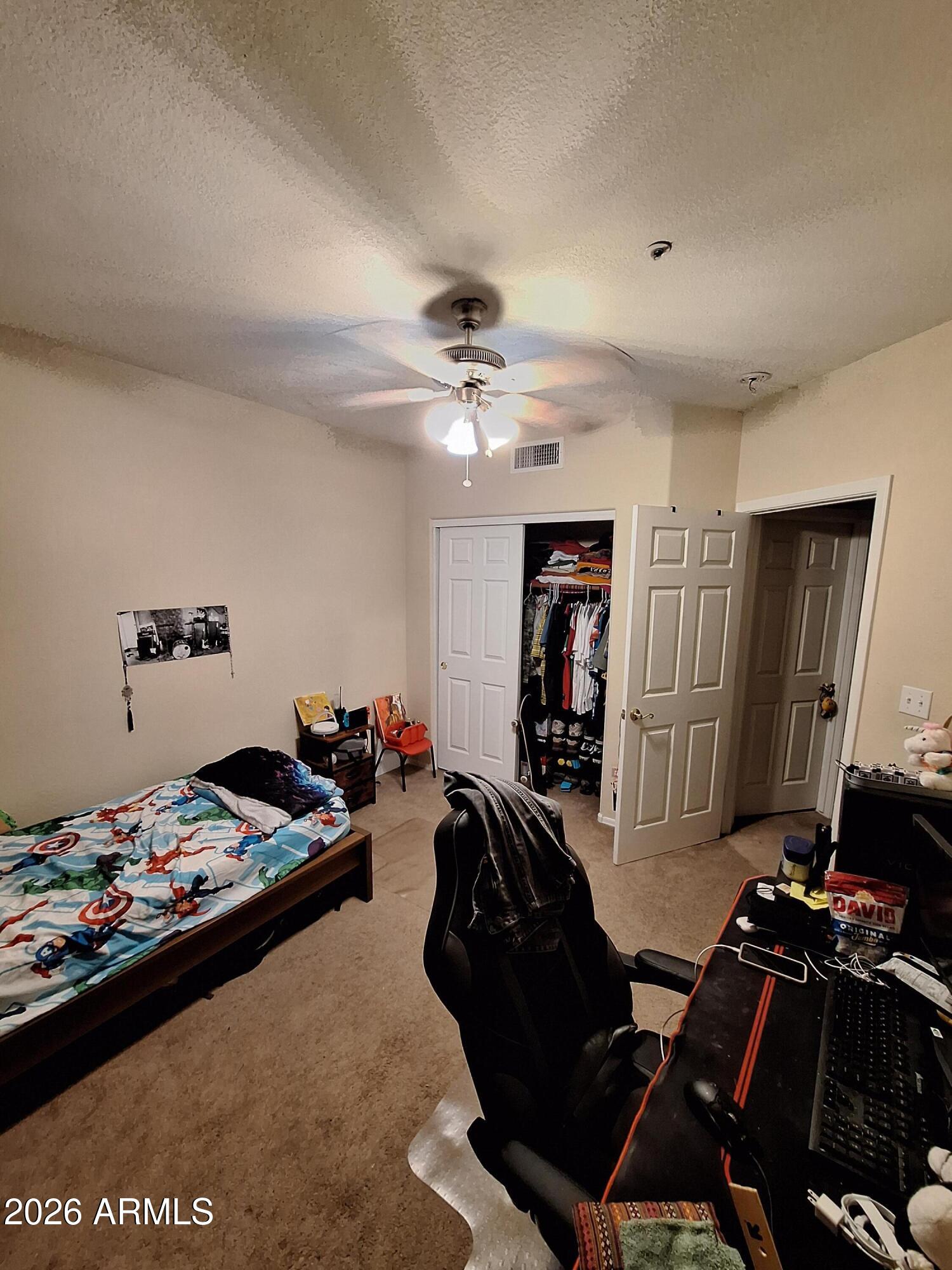 10410 North Cave Creek Road, Unit 2063 Phoenix, AZ 85020 - Photo 34 of 49 a room with furniture gym equipment and a chandelier