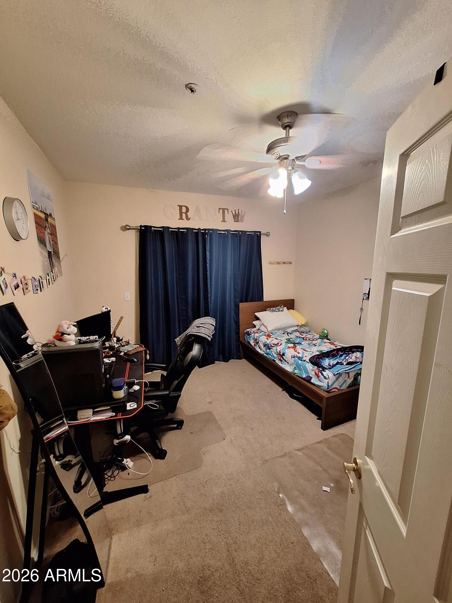 10410 North Cave Creek Road, Unit 2063 Phoenix, AZ 85020 - Photo 35 of 49 a bedroom with furniture and a fan