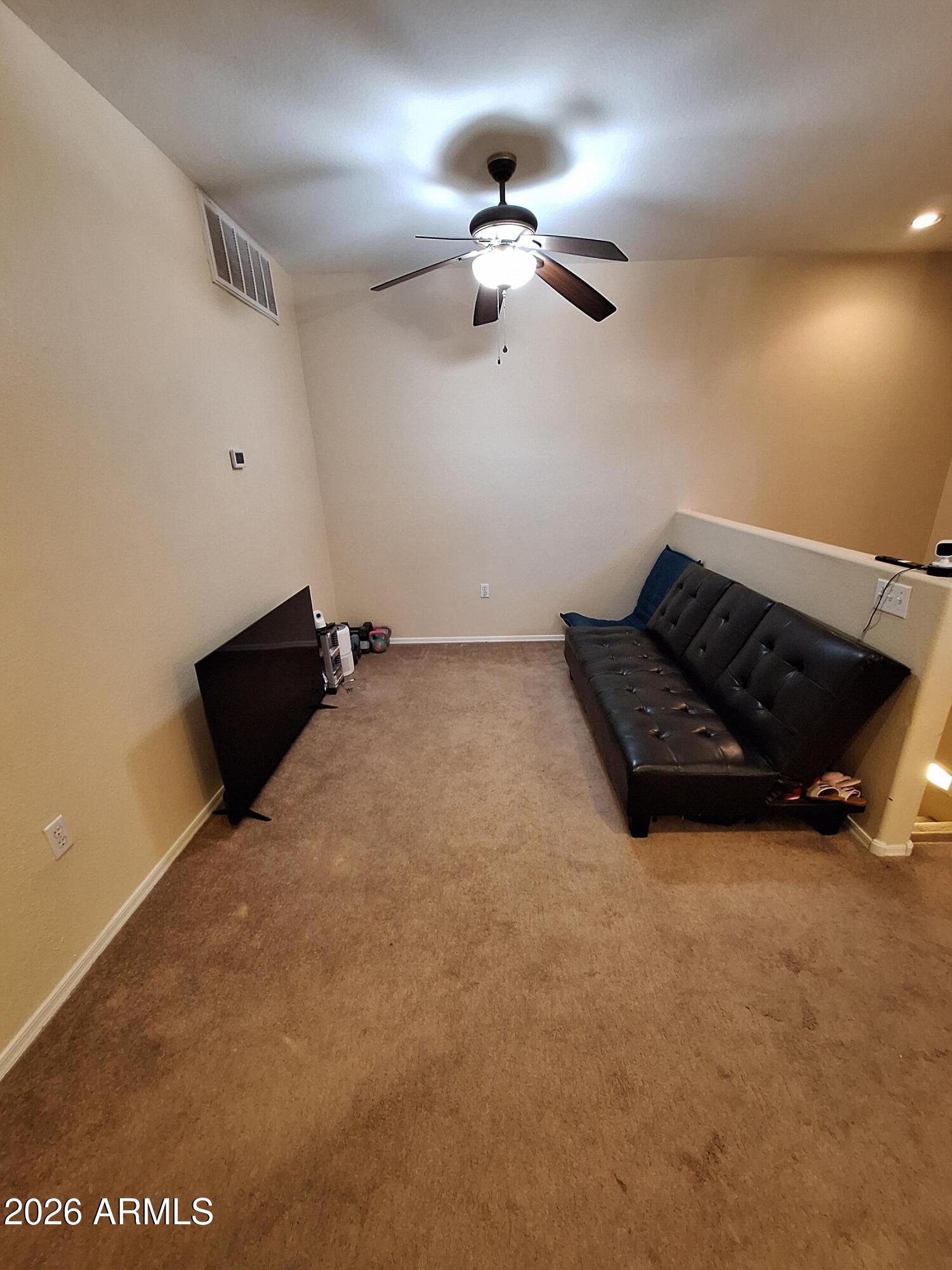 10410 North Cave Creek Road, Unit 2063 Phoenix, AZ 85020 - Photo 37 of 49 a bed room with a bed and a chandelier