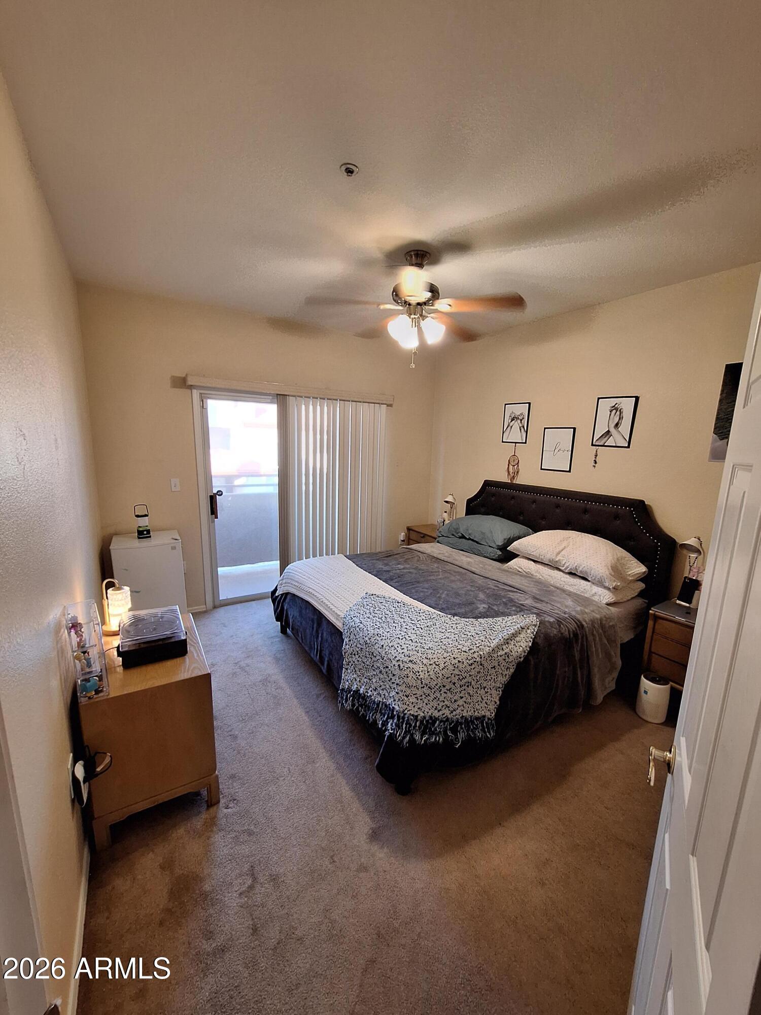 10410 North Cave Creek Road, Unit 2063 Phoenix, AZ 85020 - Photo 40 of 49 a spacious bedroom with a bed a couch and dresser