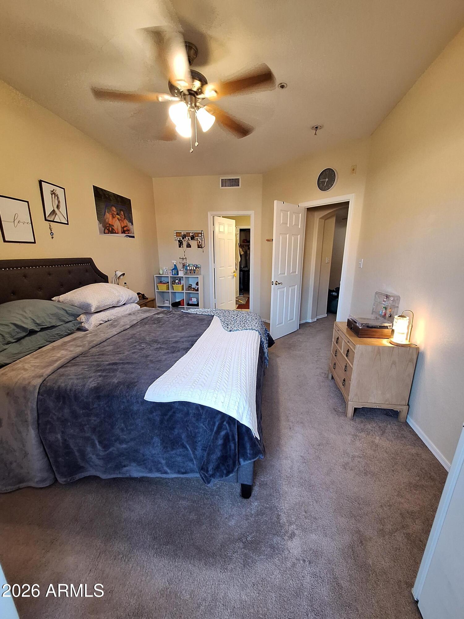 10410 North Cave Creek Road, Unit 2063 Phoenix, AZ 85020 - Photo 42 of 49 a spacious bedroom with a bed and ceiling fan