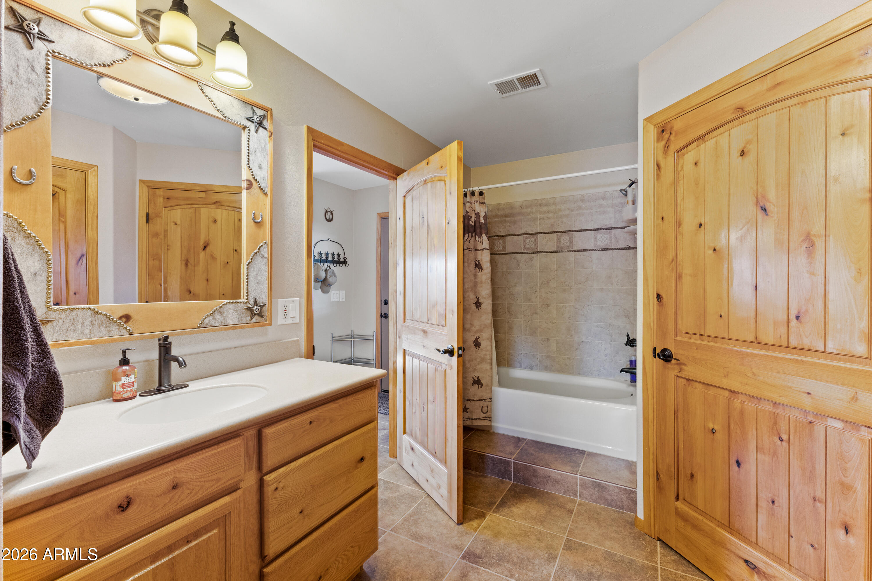 20526 West Carver Road Buckeye, AZ 85326 - Photo 10 of 43 a bathroom with a double vanity sink mirror double and shower